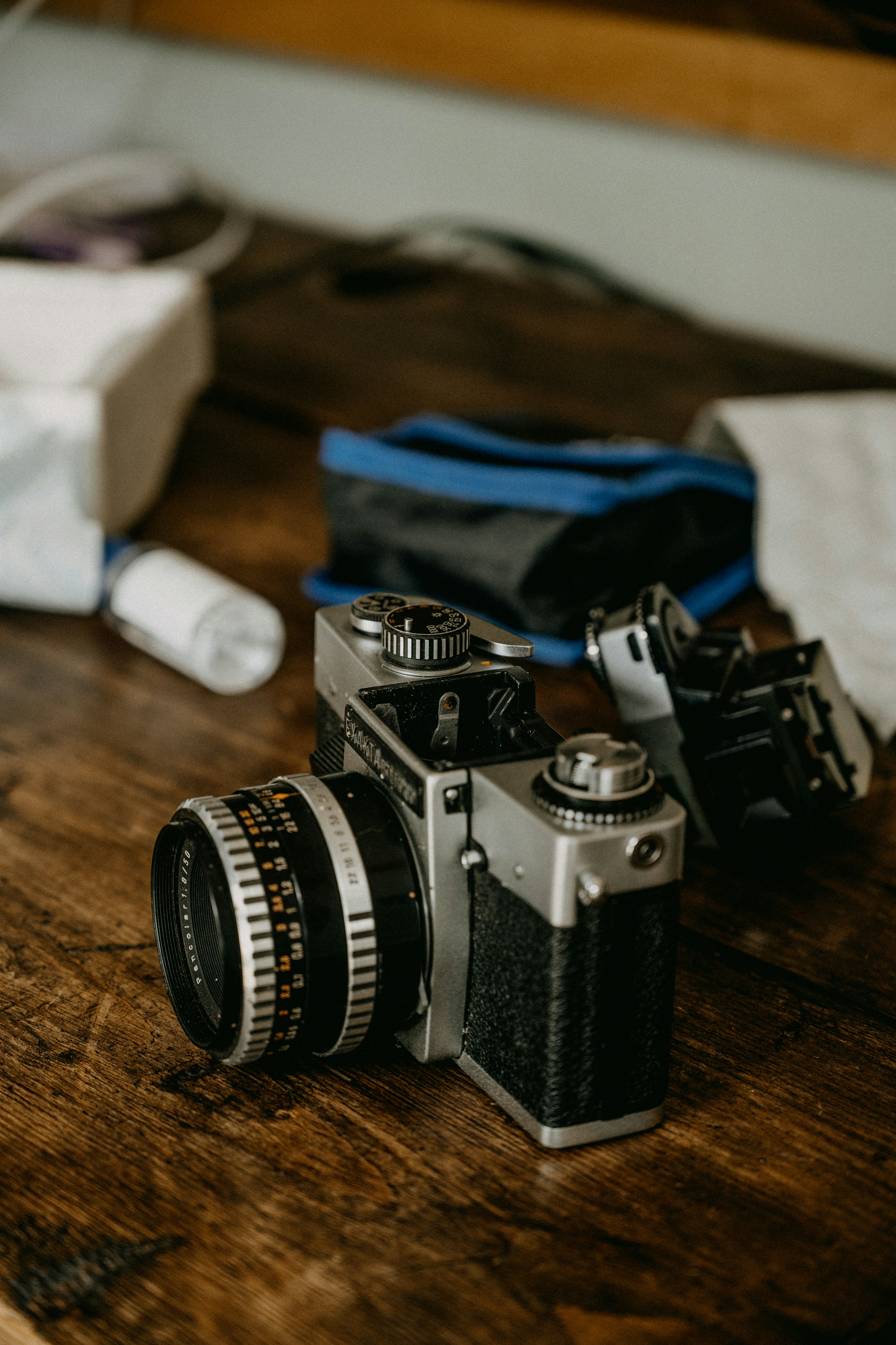 black and silver dslr camera on brown wooden table